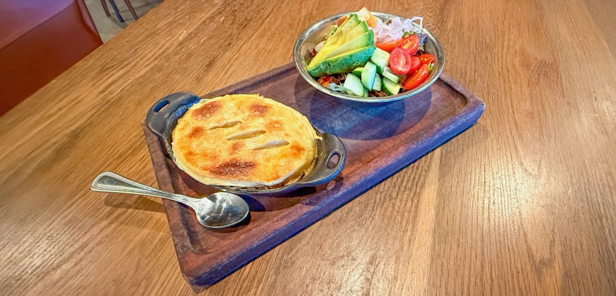 Pot Pie and Salad on a wooden board at Leftcraft in Edmonds