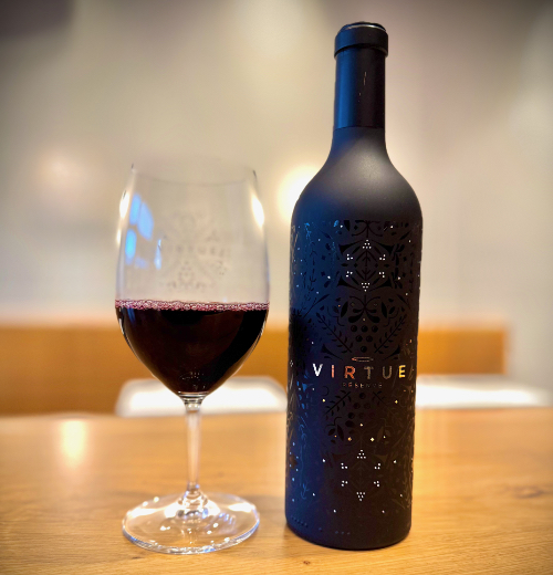 A glass of red wine and Virtue Winery bottle in Edmonds WA