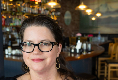 Portrait of Suzette Jarding from Ristorante Machiavelli in front of the bar in Edmonds