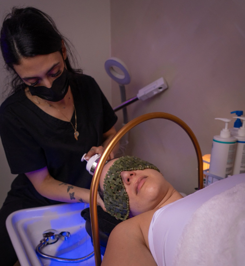 Woman giving another woman a head spa treatment at Beauty and the Barber
