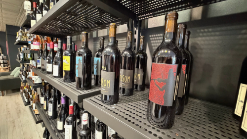 Bottles of wine on racks at Fox + Bottle in Edmonds